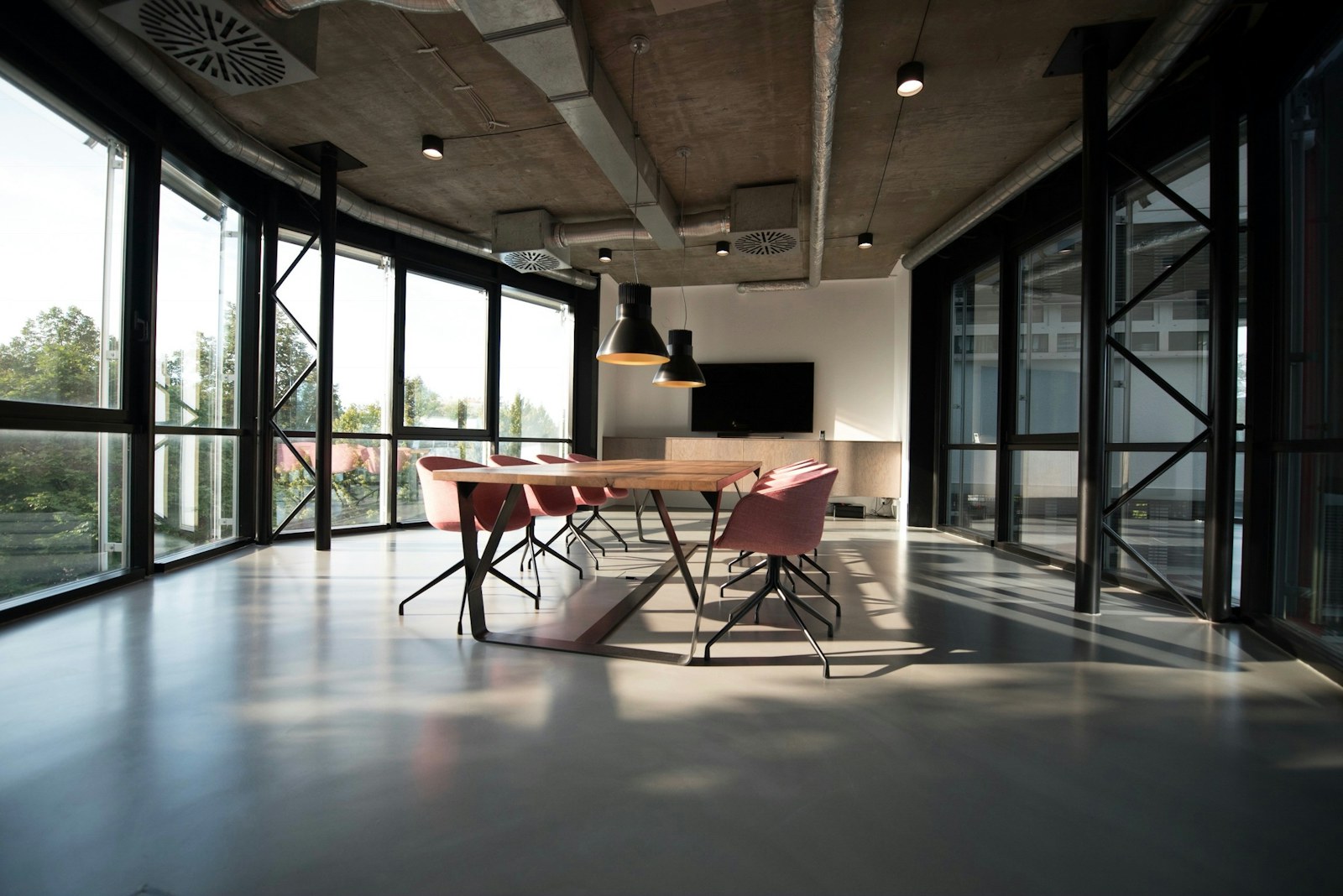Bright hospitality workspace with a large table and comfortable seating